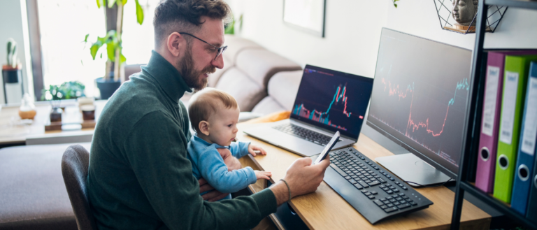 dad and child on the computer looking at investments